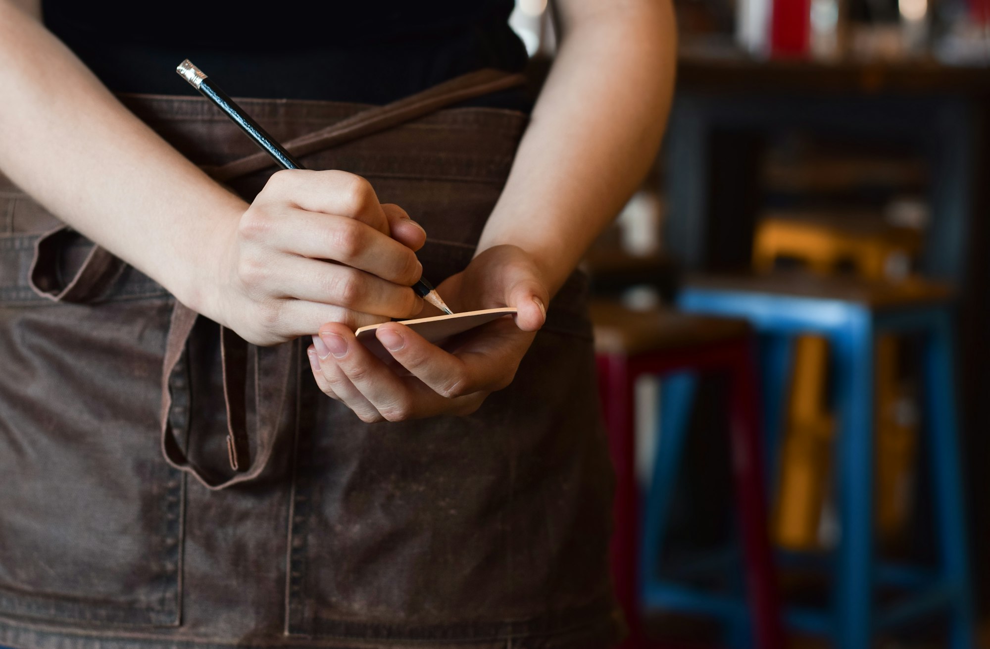 server waitress writing down food order for restaurant customers with copy space